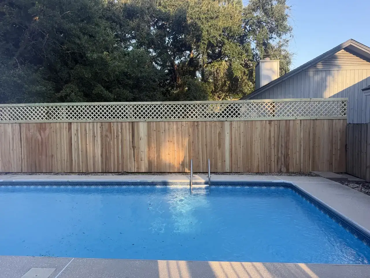 Omega Fence poolside wood fence with lattice