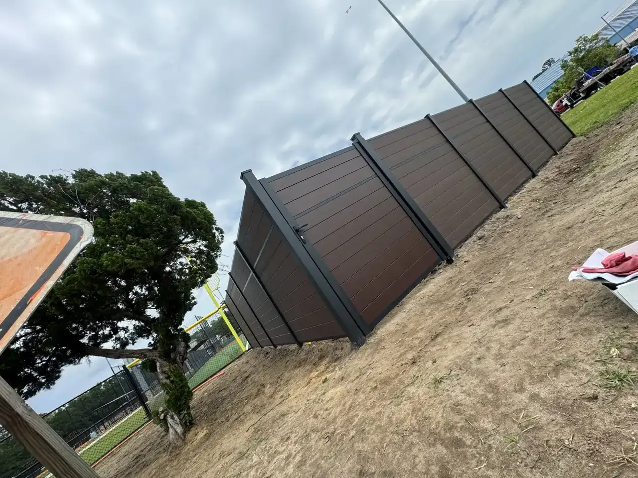 Brown privacy fence installed along a property line
