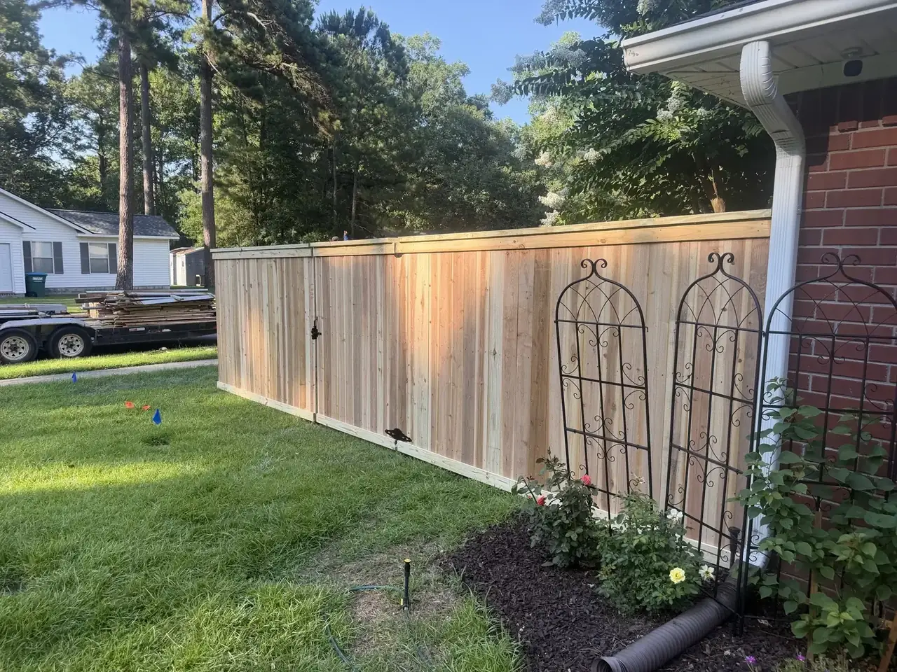 Custom Cap and Trim wood privacy fence around a home